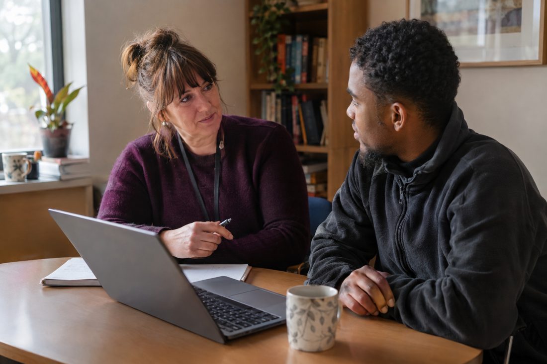 A manager and a support worker in a one-to-one conversation